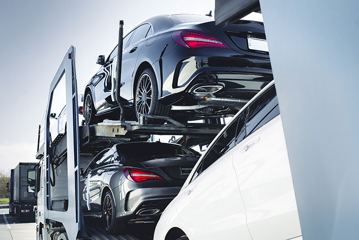 new cars on delivery truck